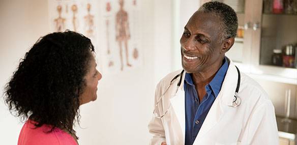 African American doctor talking to African American female patient