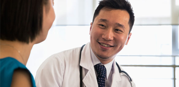 Male doctor with Asian patient