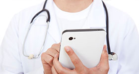 Close up of doctor holding a smart phone