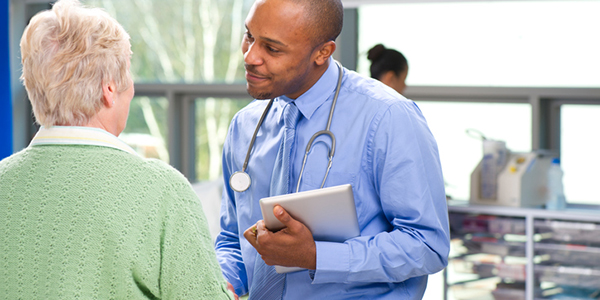 Doctor chats with senior woman patient