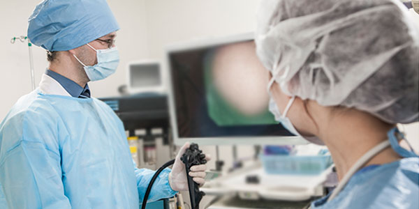 Healthcare workers performing endoscopy
