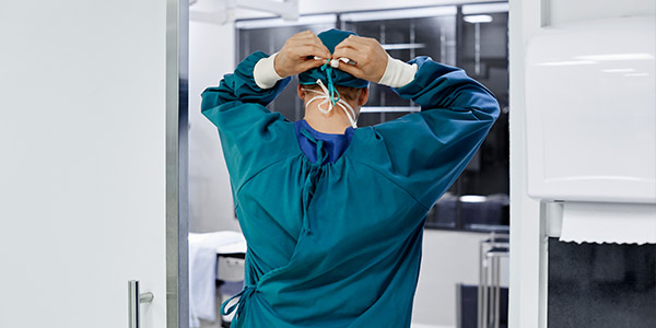 Surgeon tying mask