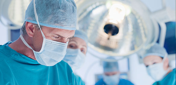 Surgeons performing operation in operating room