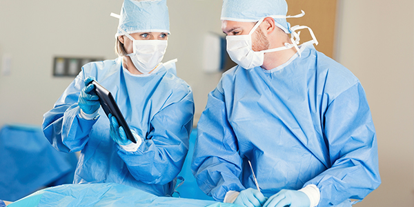 Surgeons using digital tablet