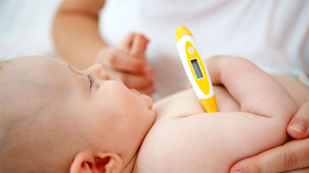 baby with thermometer under arm