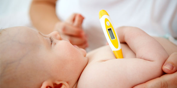 Baby with thermometer under armpit