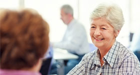 Senior woman in discussion at support group