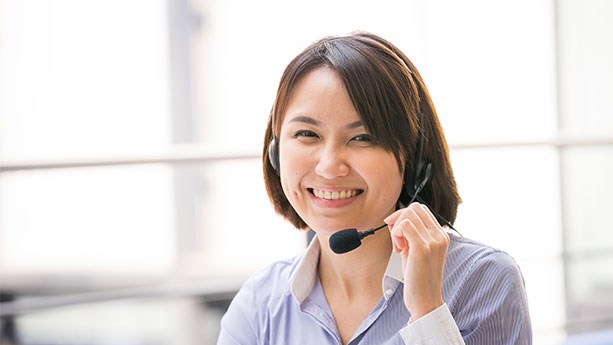 Woman smiling with operator headset on