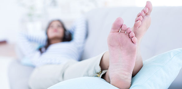 Woman with feet up on couch