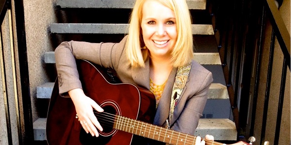 Elisha Madsen holding guitar
